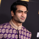 Kumail Nanjiani stands at the Eternals premiere wearing a purple paisley kurta.